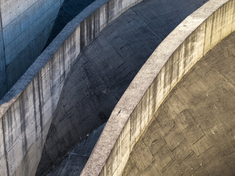 Aerial view of the concrete structures of the Niedzica Hydroelectric Power Plant, highlighting geometric lines and textures of the dam wall in Niedzica, Malopolskie, Poland.