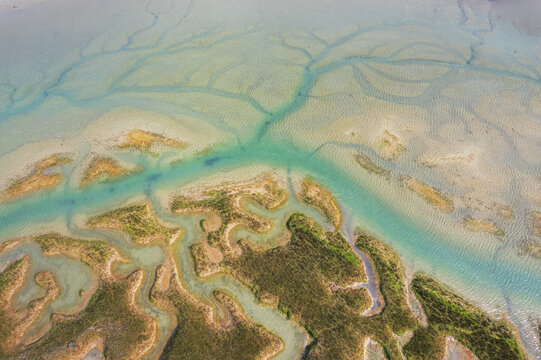 Aerial view of the intricate tidal channels and sandbanks of the Rance estuary near Saint-Suliac, Brittany, France.