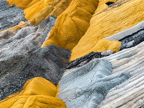 Aerial view of the colorful soil layers and geological formations at the Tagebau Hambach open-pit mine in Elsdorf, Nordrhein-Westfalen, Germany.