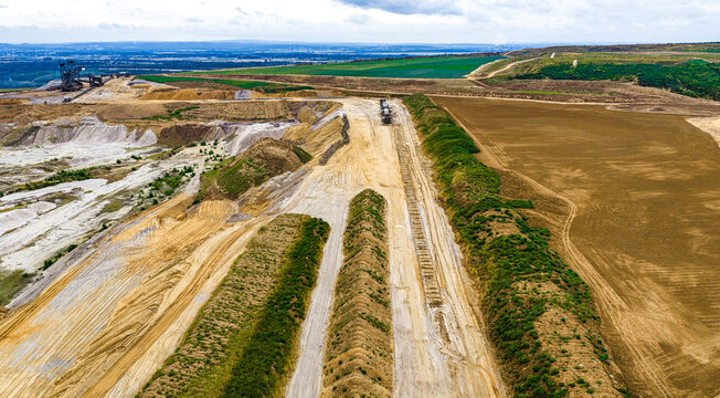 Aerial view of Tagebau Hambach showing the vast open-pit mine excavation site with industrial earthworks and layered soil Elsdorf, Nordrhein-Westfalen, Germany.