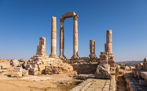 View of the ancient Temple of Hercules columns at the Amman Citadel, set against a clear blue sky in Amman, Amman Governorate, Jordan.