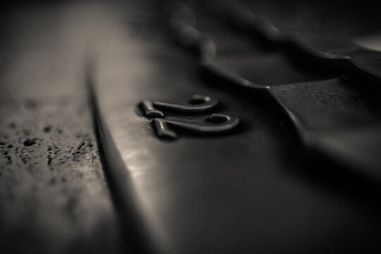 View of the number 22 embossed on a dark metallic surface with shallow depth of field in Los Angeles, California, United States.