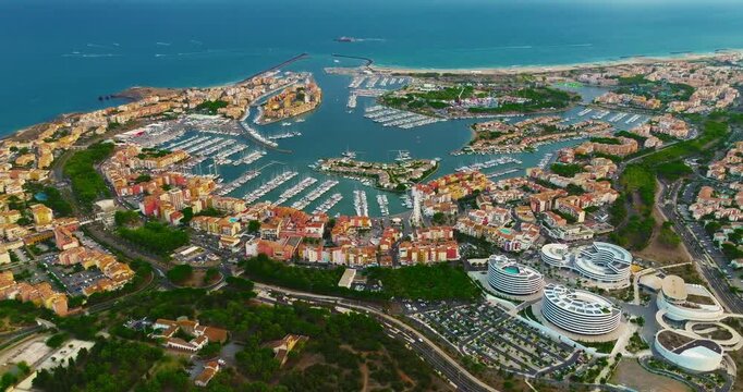 Aerial view of picturesque Mediterranean marina in the town of Agde, featuring sailing yachts. A popular seaside resort in the south of France, known for its sandy beaches, yachting