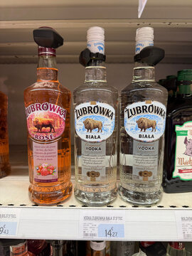 Zubrowka Rose and Biala vodka bottles fitted with security tags on a shop shelf, with price labels below - Rouen, France - September 5, 2026