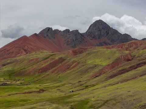 Aerial view of the vibrant red slopes and green valleys of the Red Valley near Vinicunca in the Andes mountains, Cusco, Cuzco, Peru.