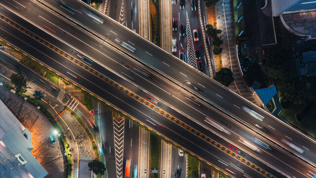 Aerial view of a busy highway interchange with light trails in Jakarta, Indonesia.