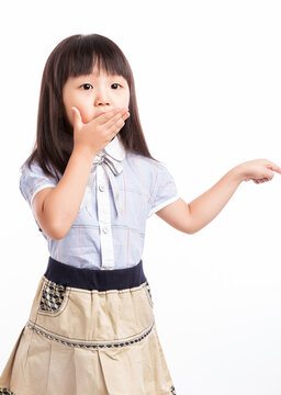 Little girl covering her mouth with hands, feeling shocked or keep a secret.