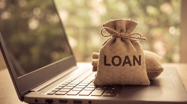 Online Loan Concept with Money Bag on Laptop Keyboard