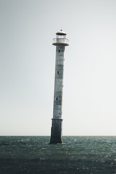 View of the iconic leaning Kiipsaare lighthouse standing in the sea under a clear sky in Koruse-Metsakyla, Saare County, Estonia.