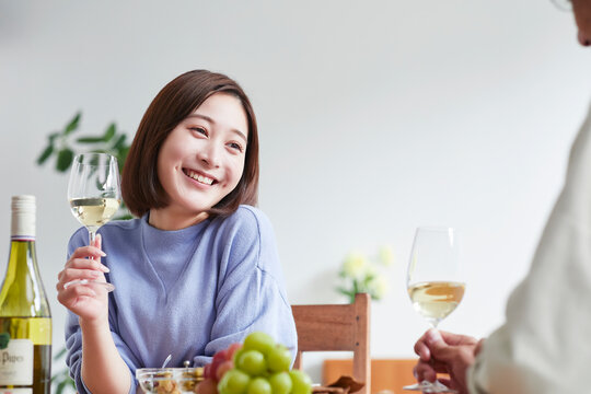 お酒を呑みながら食事をする女性と男性
