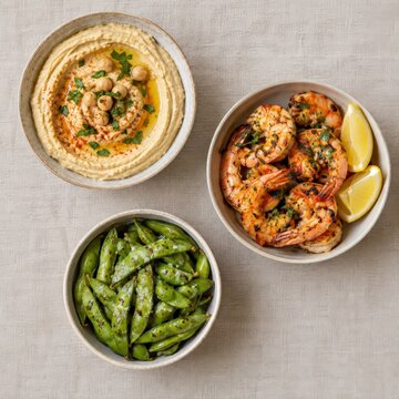 Trio of appetiser dishes on a plain linen surface