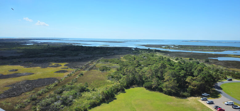 View of the coastal marshlands and waterways of the Outer Banks under a clear blue sky in Nags Head, North Carolina, United States.
