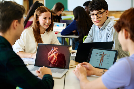 Students learning biology using digital devices in classroom