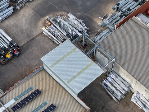 Melbourne, VIC, Australia - 05 October 2026: Aerial view of industrial factory site in Boronia and Bayswater featuring metal components, storage areas, and solar panels on the roof.