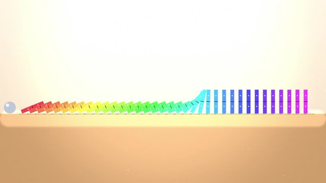 Rainbow dominoes falling in sequence on light surface with particle effects creating satisfying motion loop