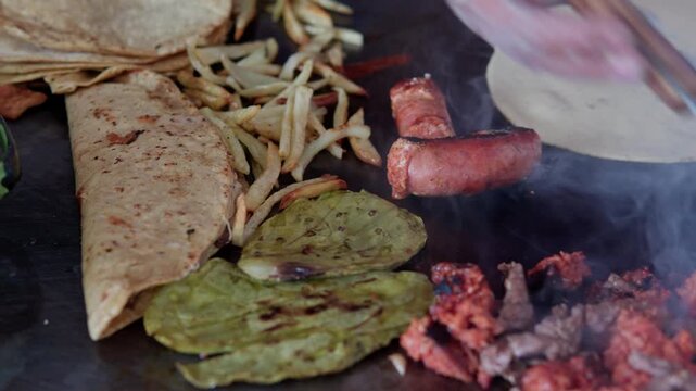 Chef cooking authentic mexican tacos on a griddle