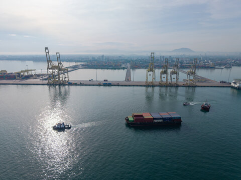 Butterworth, Pulau Pinang, Malaysia - 10 June 2026: Aerial view of North Butterworth Container Terminal with gantry cranes, cargo ships, and tugboats in the port.