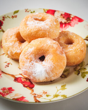 A simple doughnut with tempting powdered sugar.