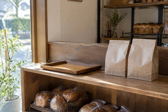 Paper bags of bread at a bakery pickup shelf