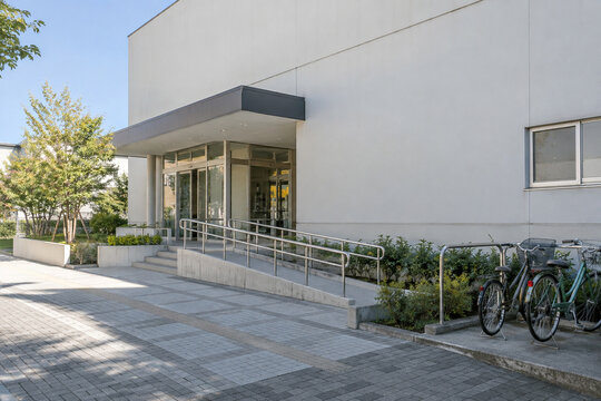 Public building entrance with access ramp and bicycle parking
