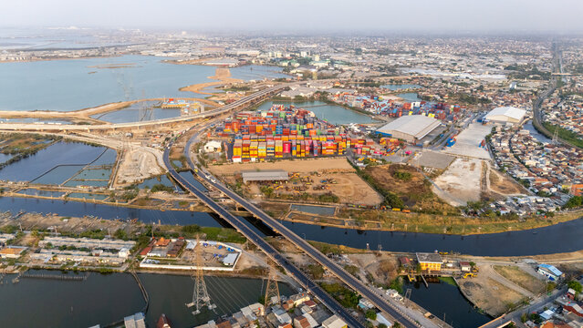 Semarang Utara, Indonesia - 27 September 2026: Aerial view of Pelabuhan Tanjung Emas port with shipping containers, warehouses, and coastal infrastructure in Central Java.