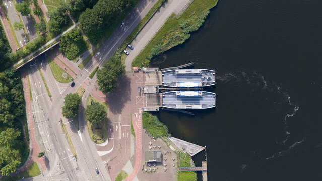 Velsen-Noord, Netherlands - 20 June 2026: Aerial view of the Ferry Velsen-Noord terminal with two ferries docked at the pier, surrounded by roads, greenery, and parking areas.