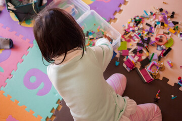 家でレゴのオモチャを遊んでいる幼児の女の子の様子 © zheng qiang