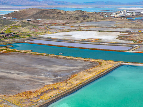 Ogden, Utah, United States - 30 September 2026: Aerial view of Compass Minerals Ogden with vibrant turquoise and purple evaporation ponds, white salt mounds, and industrial facilities.
