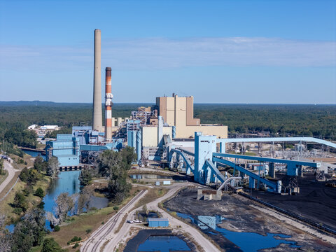 West Olive, Michigan, United States - 28 September 2026: Aerial view of Consumers Energy J.H. Campbell Generating Complex with tall smokestacks and industrial buildings near a waterway.