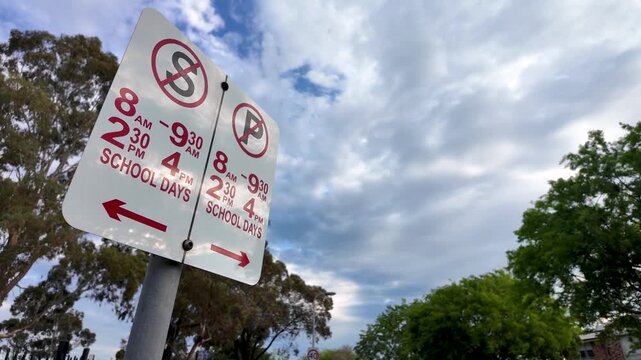 School zone parking restriction sign in Australia, with a no stopping symbol and a no parking symbol, school-day time restrictions and arrows. Drop-off and pick-up congestion control, traffic managent