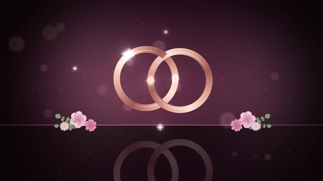 Rose gold wedding rings linking with reflection and pink blossoms