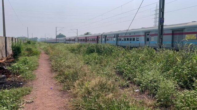 Passenger train hauled by a WAP7 electric locomotive near Pune India.