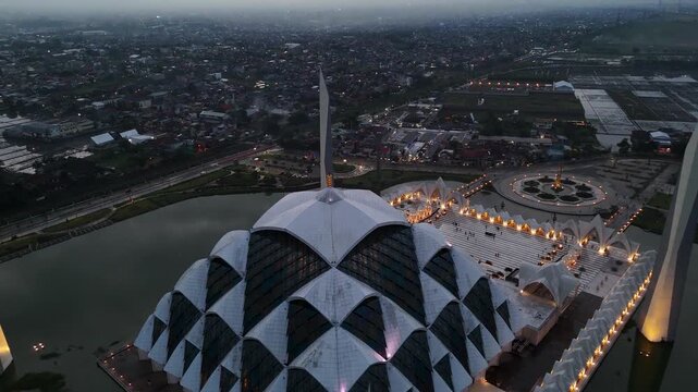 Aerial view of Al Jabbar Grand Mosque with its geometric dome and surrounding water features in Bandung, West Java, Indonesia.