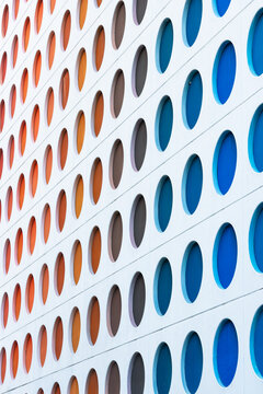 Modern building facade featuring colorful geometric circle pattern