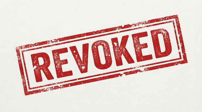Distressed red rubber stamp with revoked text isolated on white paper background