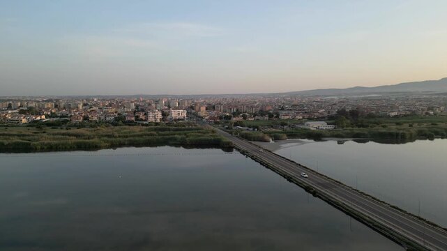 Aerial view of the FAI - Saline Conti Vecchi wetlands and the bridge leading to the town of Assemini, Sardegna, Italy.