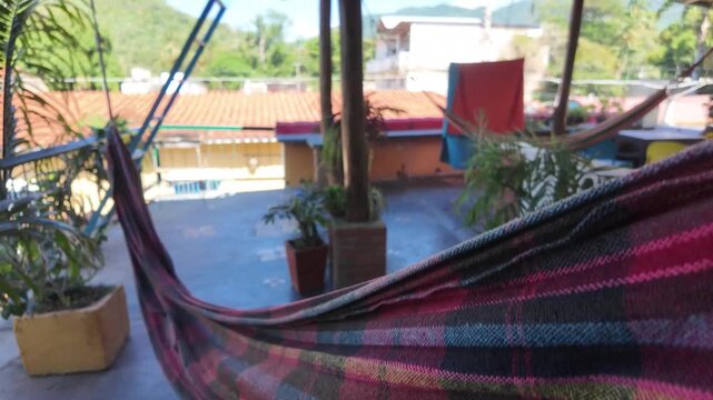 Colorful hammock on a plant-filled terrace above Choroni rooftops
