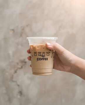 Hand Holding a Plastic Cup of Iced Coffee with Customization Checkboxes