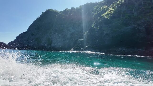 Boat ride with wave splash along turquoise Caribbean cove, Venezuela