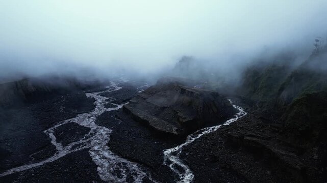 Fog Drifting across Braided River and Eroded Rock Formations