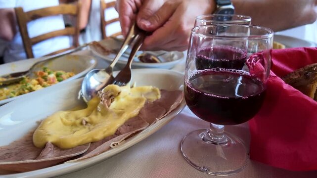 Serving Traditional Vitello Tonnato with Red Wine at Italian Restaurant