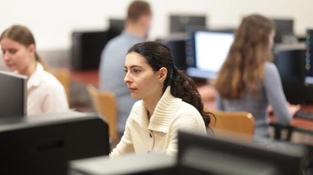 Portrait of young female student studying in university computer class 