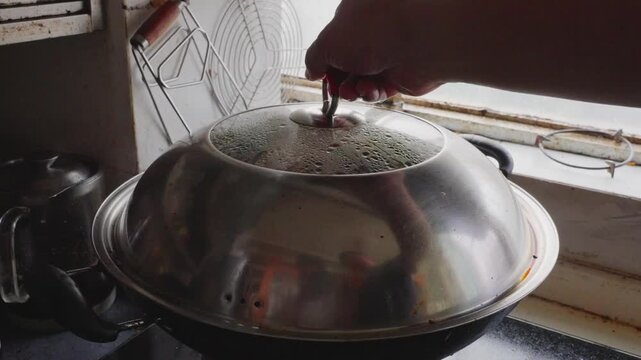 Lift the lid of the stove steamer to reveal Nanning's traditional dish of drunken duck with mushrooms