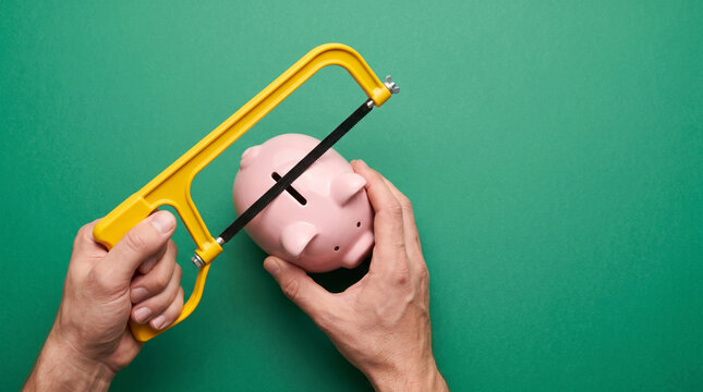 Piggy bank broken by hacksaw with coins. Finance bankruptcy debt crisis. investment budget risk loss, saving piggybank money wealth, poverty