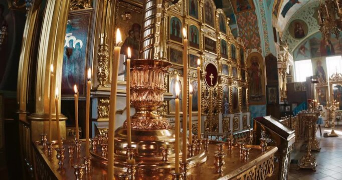 Golden Candle Stands and Gilded Iconostasis Inside an Orthodox Church