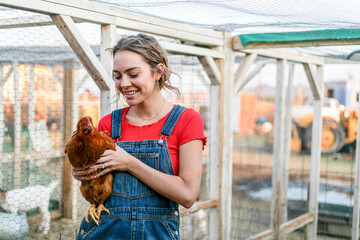 Woman holding chicken outdoors farm © Rawpixel.com