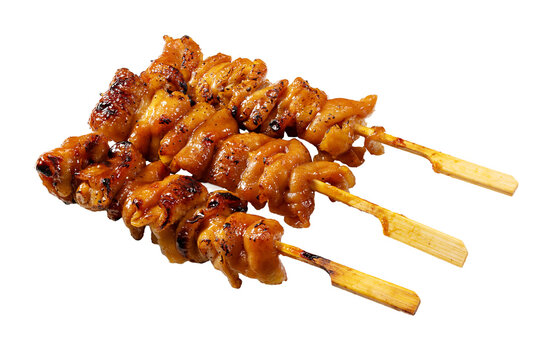 Three Japanese grilled chicken skewers yakitori with tare sauce isolated on transparent background