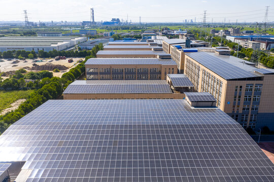 Rows of solar panels installed on factory rooftops in industrial zone