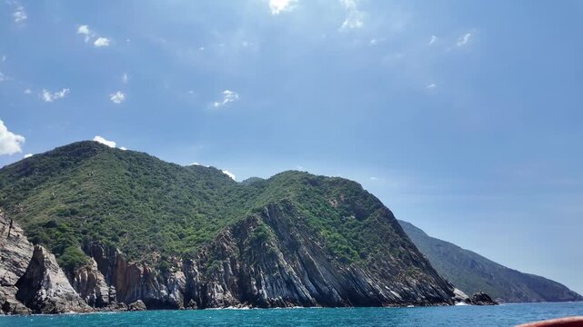 Green mountain coastline seen from a boat on the Caribbean coast