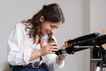 Fototapeta premium Scientific discovery and education, young woman using a telescope for astronomy research and space exploration in a classroom or home office setting